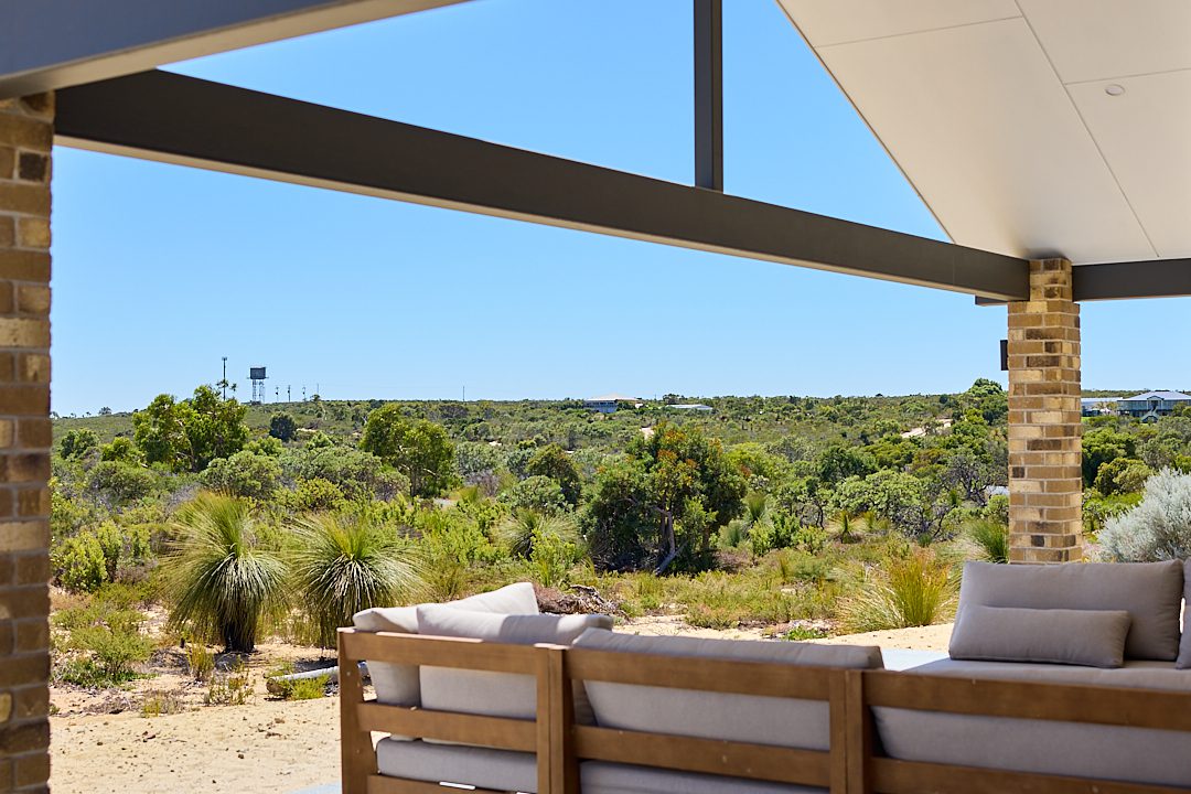 A custom farmhouse, client home in Karakin in Western Australia, in the Wheatbelt region and Shire of Gingin, features a raked outdoor alfresco that overlooks the bushland, built by WA Country Builders