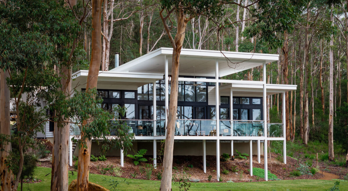 Home construction methods in Perth and Regional WA, including double brick, brick veneer, framed construction, and more. Aerial view of an integrated frame construction of a home in regional WA. Built by WA Country Builders. WA Country Builders home in the South West of WA, elevated on steel stilts among tall karri trees.