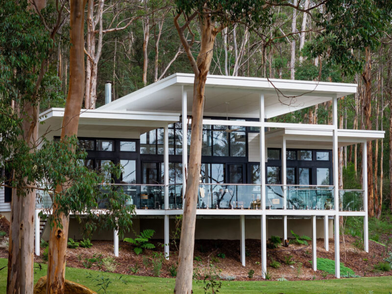 Home construction methods in Perth and Regional WA, including double brick, brick veneer, framed construction, and more. Aerial view of an integrated frame construction of a home in regional WA. Built by WA Country Builders. WA Country Builders home in the South West of WA, elevated on steel stilts among tall karri trees.